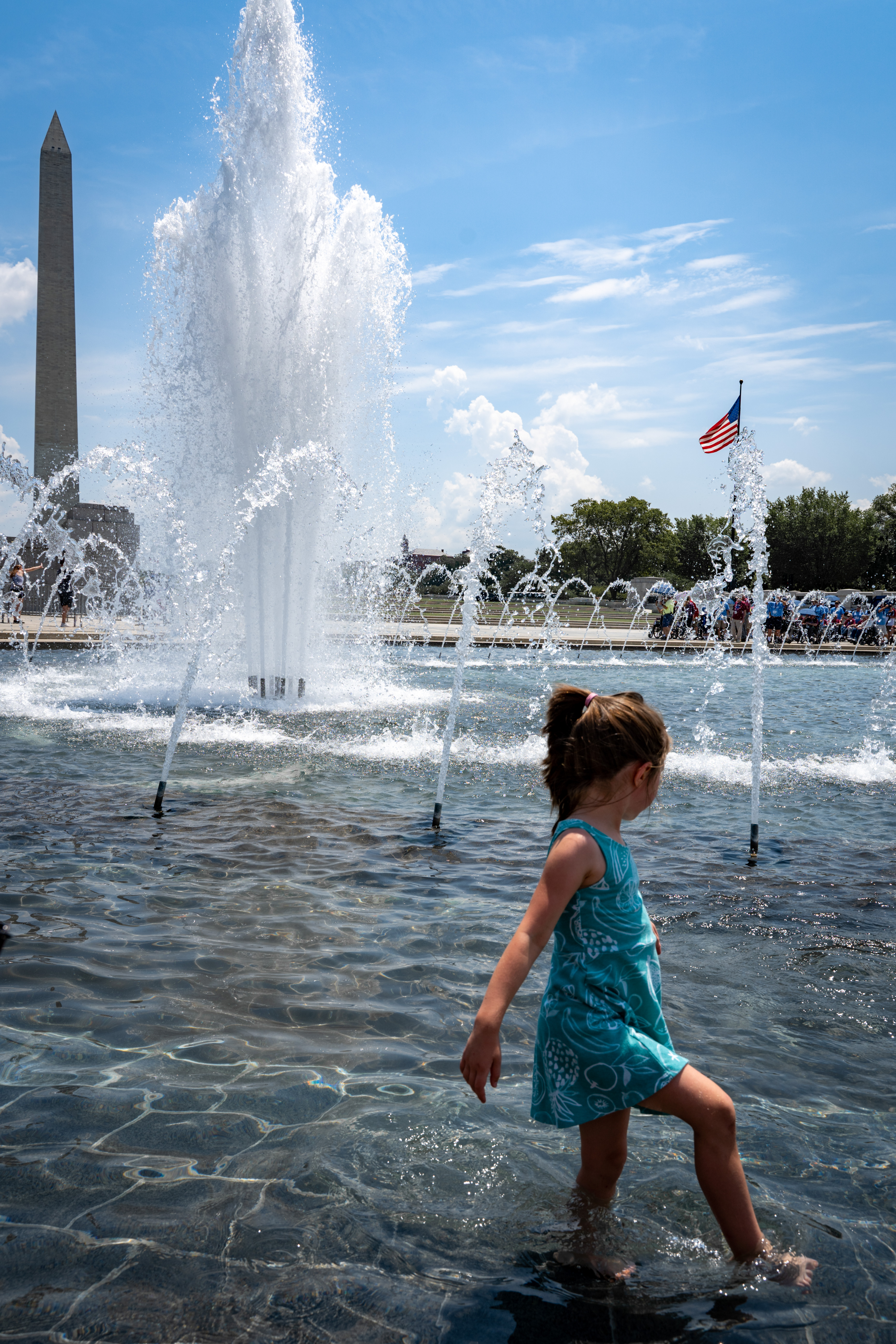 Child playing in World War 2 memorial pond